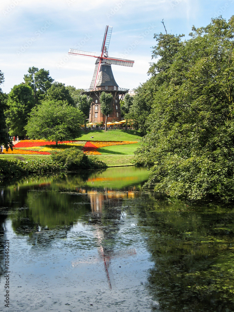 Lake in Wallenlagen Park in Germany reflecting the historic windmill on its shores Lake in Wallenlagen Park in Germany reflecting the historic windmill on its shores