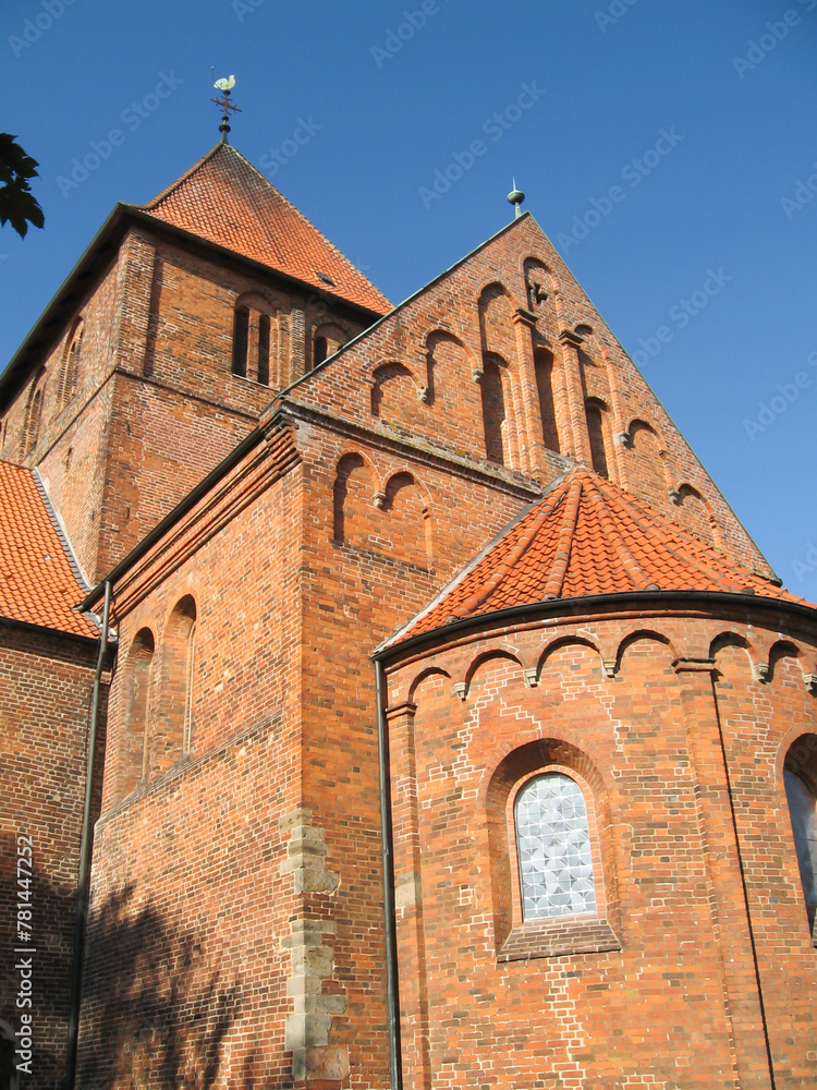 Looking up at the belltower of the 13’th century brick church at the cannon monastery in the German Town of Bassum on a clear sunny day. Looking up at the belltower of the 13’th century brick church at the cannon monastery in the German Town of Bassum on a clear sunny day.