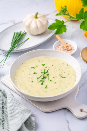 Spring white creamy zucchini soup with herbs