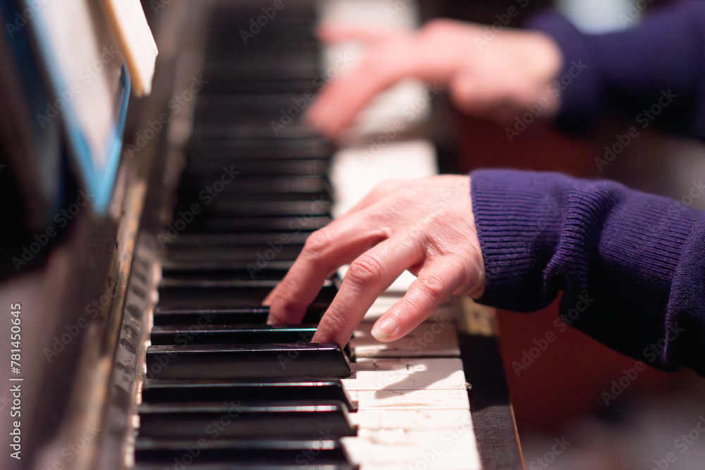 Fototapeta premium fingers close up playing piano music, used old dusty authentic instrument 