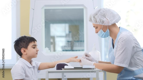 A doctor takes a patient's blood sample from a finger prick. Child's blood test. Blood test, blood group determination and medicine concept photo