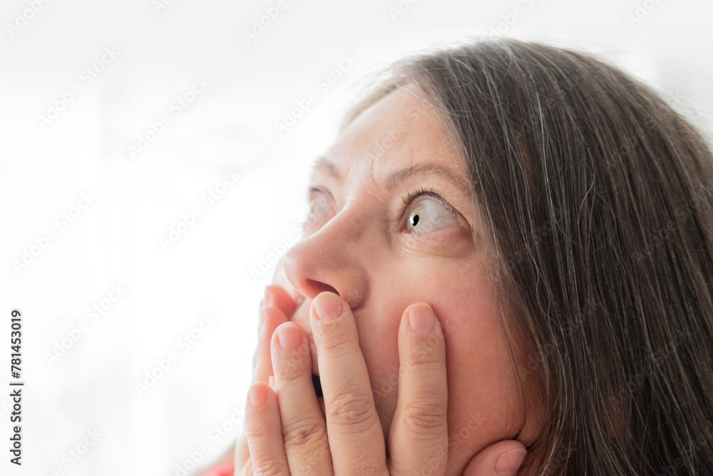mature scared woman with bulging eyes, face close-up, goggle eyes in fright, staring in waking nightmare, Very strong surprise or shock, fright, universal horror in look mature scared woman with bulging eyes, face close-up, goggle eyes in fright, staring in waking nightmare, Very strong surprise or shock, fright, universal horror in look