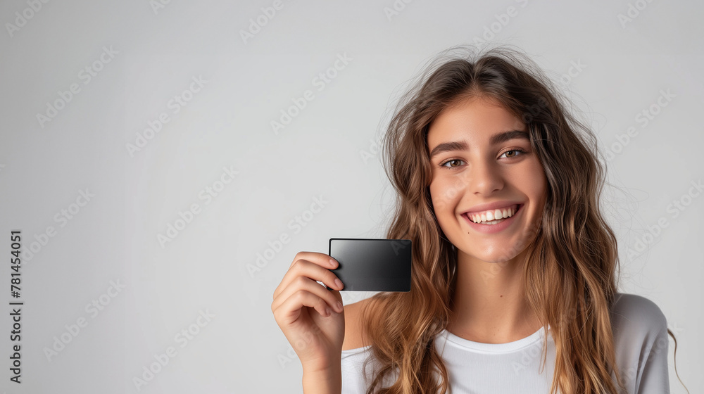 smiling woman holding a blank credit card smiling woman holding a blank credit card