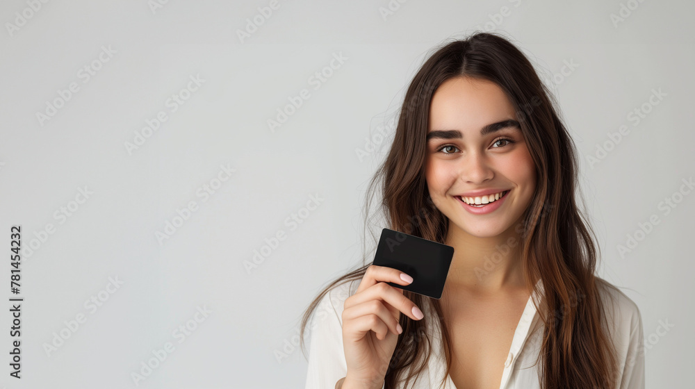 smiling woman holding a blank credit card smiling woman holding a blank credit card