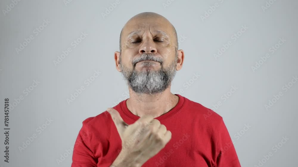 bald bearded man in a red shirt making a thumbs up sign to the right side.