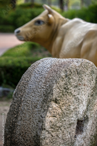 View of the mill stone and bull in the rural village photo