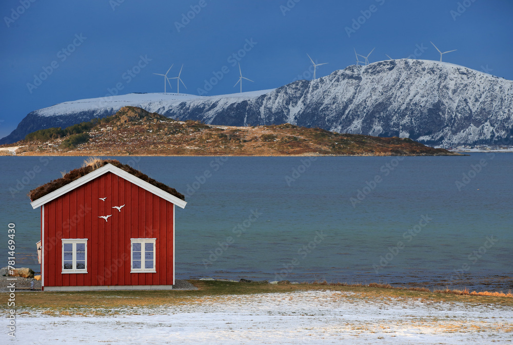Winter landscape with red boathouse near Alesund, Norway.