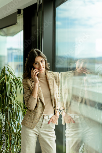 Elegant young woman using m...