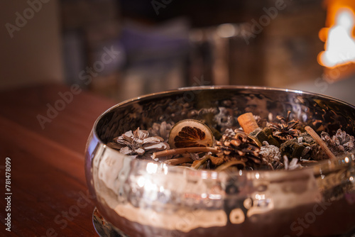 Close up view of decorative bowl with dried natural items like citrus slices, cinnamon sticks, and pine cones. Possibly in luxury Zermatt ski resort in Switzerland.