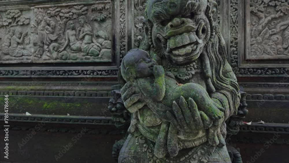 Alien statue holding a baby in the  Monkey Forest. Ubud, Bali, Indonesia.