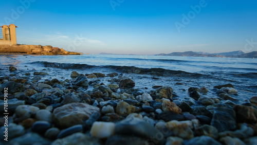 A rocky beach with the waves coming towards the beach in the early morning.