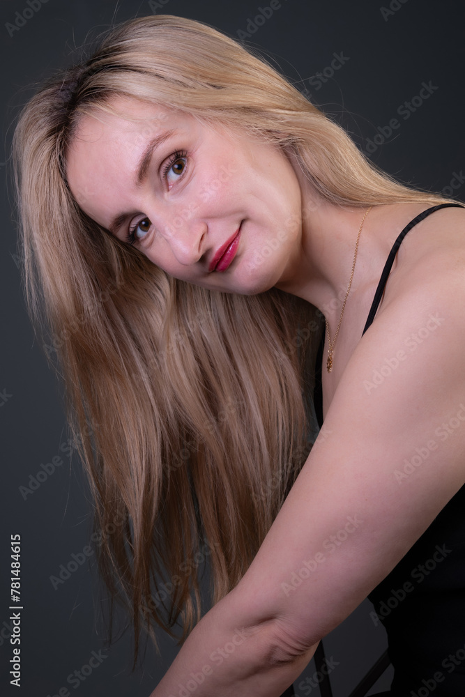 Portrait of a white blonde woman in black dress and red lipstick. Portrait of a white blonde woman in black dress and red lipstick.