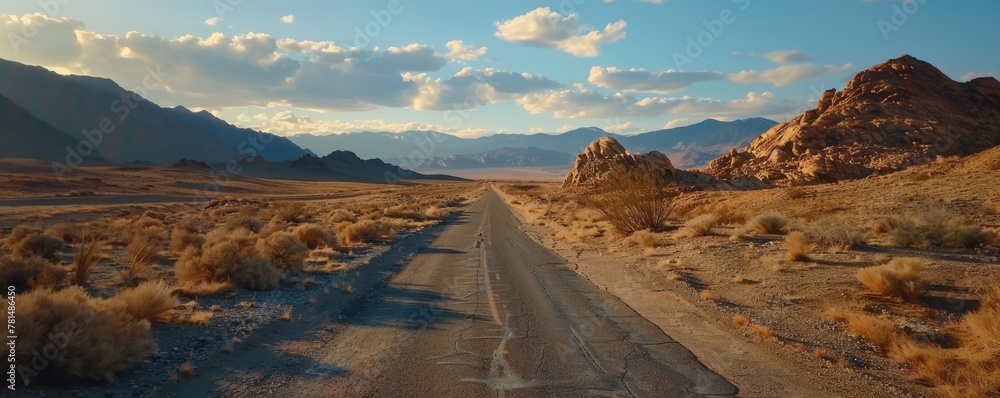 Vast desert road at sunset