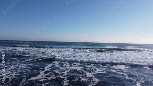 Wallpaper Mural Flying low over an ocean, sea or water as the sun sets on the horizon 3D animation.Spiral Flying (top aerial view) over the turquoise color ocean waves next to the beach. Torontodigital.ca