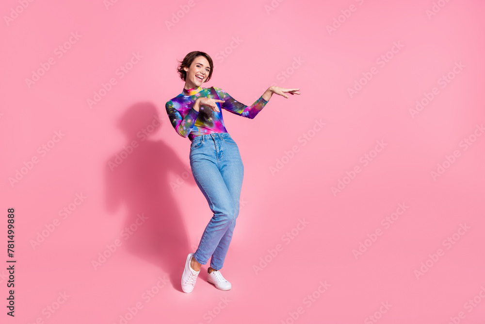 Full size photo of nice young woman arms dance empty space wear pullover isolated on pink color background
