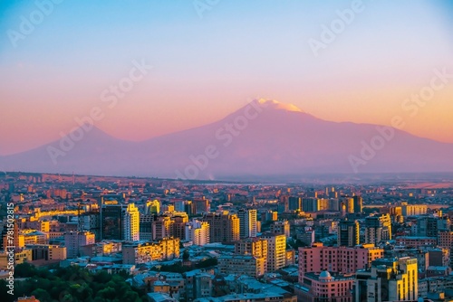 Breathtaking aerial view of the Yerevan cityscape with the silhouette of Mount Ararat on sunset sky