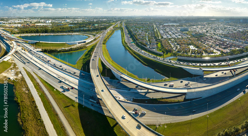 USA transportation infrastructure concept. Above view of wide highway crossroads in Miami, Florida with fast driving cars photo