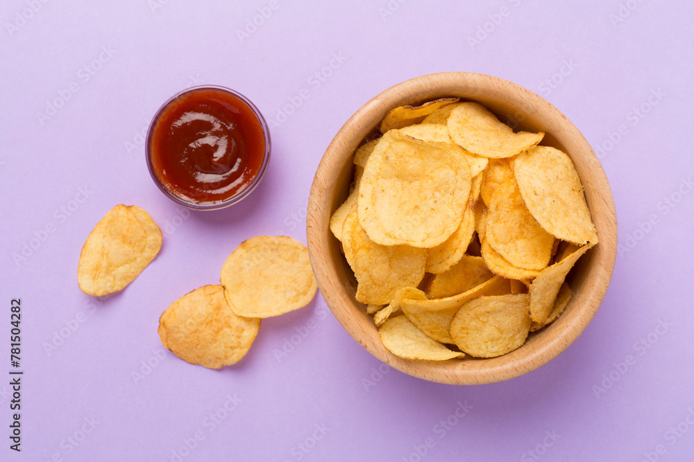 Appetizing potato chips on color background, top view Appetizing potato chips on color background, top view