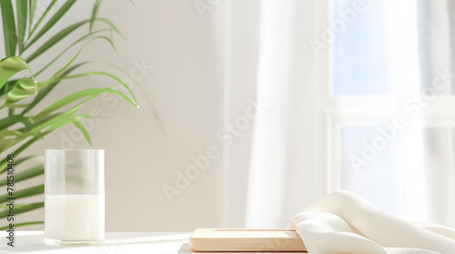background consisting of a green fern leaf, a white board on the table © Tatiana