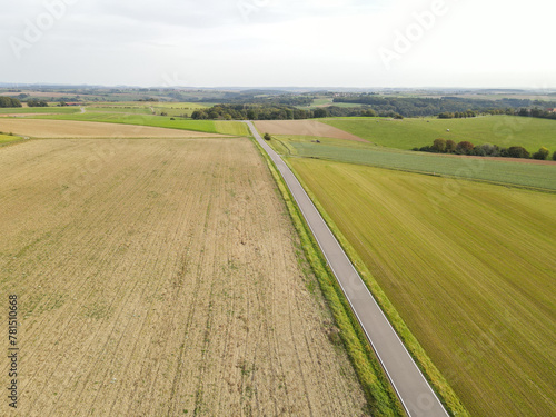 View from above of a road between fields in the farmland 