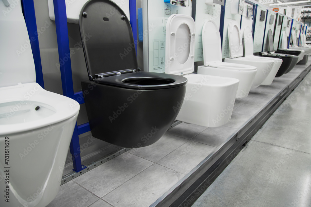 Toilet bowls in a home goods store. New modern black toilet