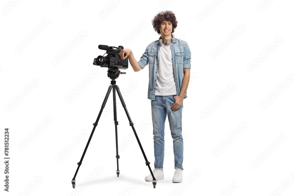 Full length portrait of a camera operator with a camera on a tripod stand