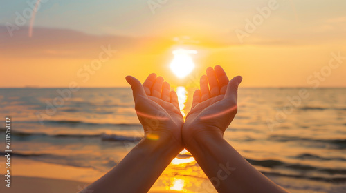 Two hands holding up to the sun on beach, symbolizing hope and joy during summer vacation with sea background. 