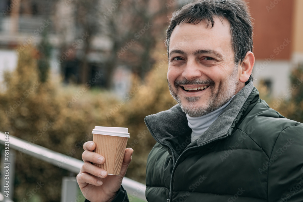 middle aged man drinking coffee outside middle aged man drinking coffee outside