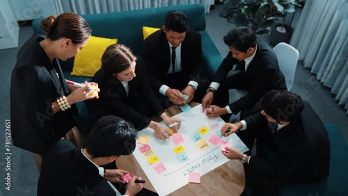 Top view of business people making scrum task board to manage workflow in workplace. Diverse marketing team drawing a line and use colorful stick notes to work on kanban. Creative office. Directorate. photo