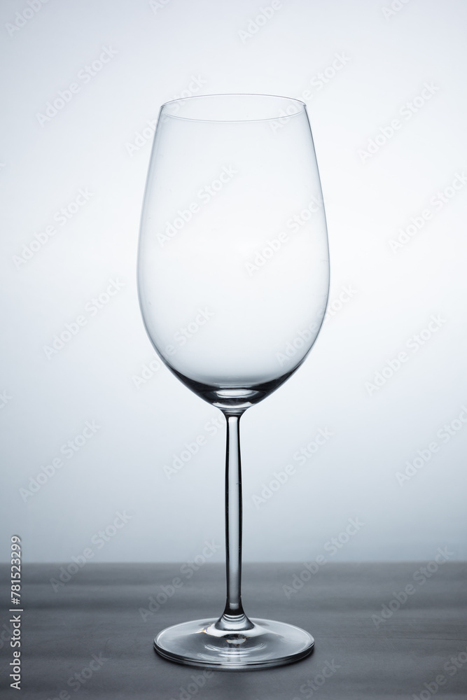clear crystal wine glass with elegant stand of empty glass without liquid, resting on a table clear crystal wine glass with elegant stand of empty glass without liquid, resting on a table
