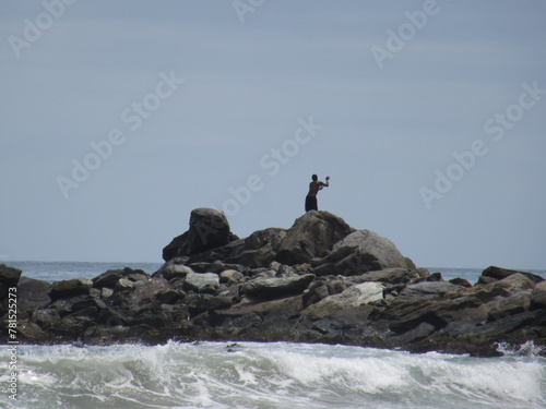 fisherman in rocks, La Guaira, Venezuela photo