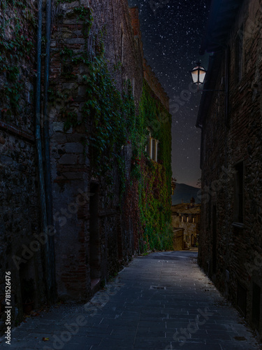 The colorful medieval houses and alleys of a Tuscan village at night