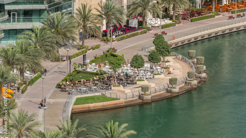 Waterfront promenade in Dubai Marina aerial timelapse. Dubai, United Arab Emirates
