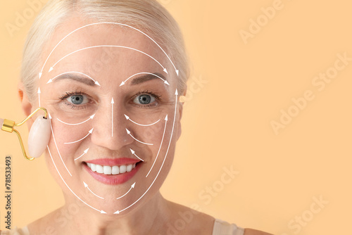 Mature woman with facial massage tool on color background