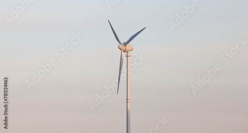 Green energy wind turbine against sky