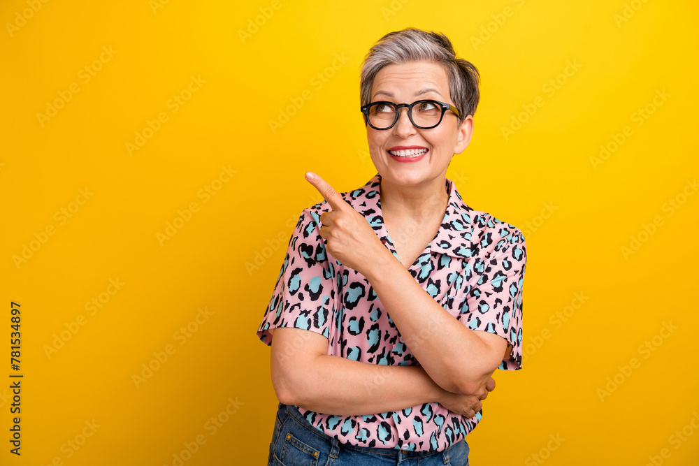 Fototapeta premium Photo portrait of pretty retired female point look empty space wear trendy leopard print outfit isolated on yellow color background