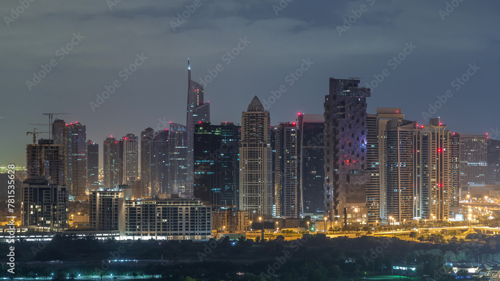 Jumeirah lake towers skyscrapers and golf course night to day timelapse, Dubai, United Arab Emirates