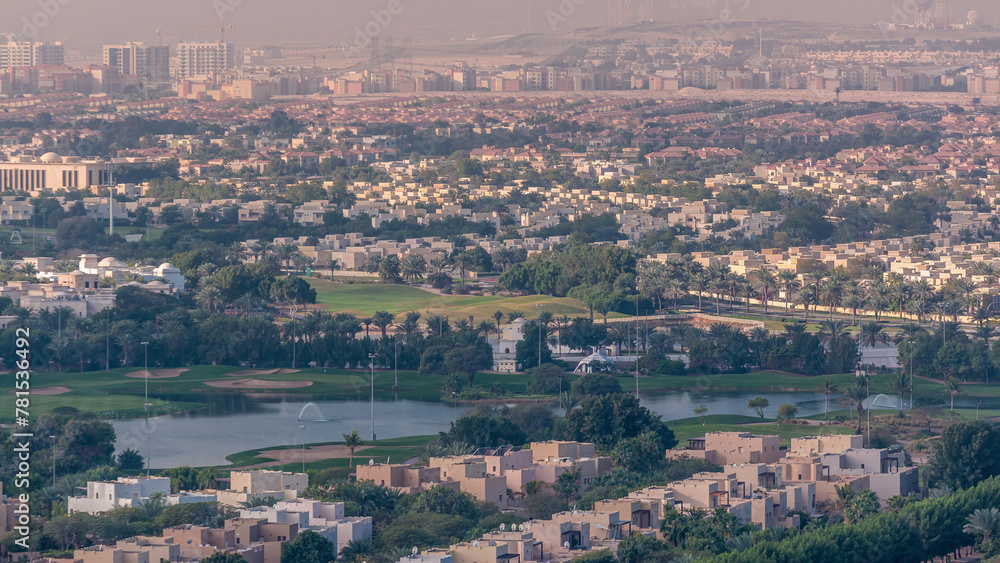 Aerial view to villas and houses with Golf course with green lawn and lakes timelapse Aerial view to villas and houses with Golf course with green lawn and lakes timelapse