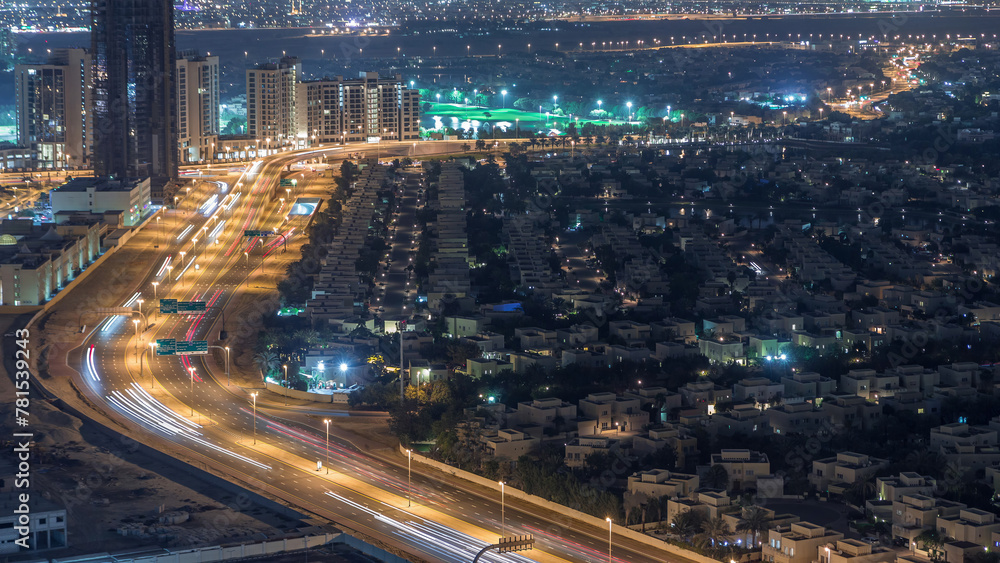 Aerial view of apartment houses and villas in Dubai city night timelapse, United Arab Emirates