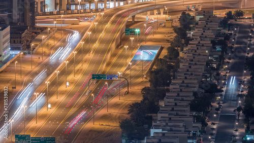 Traffic on the road in Jumeirah Lakes Towers district aerial night timelapse. photo