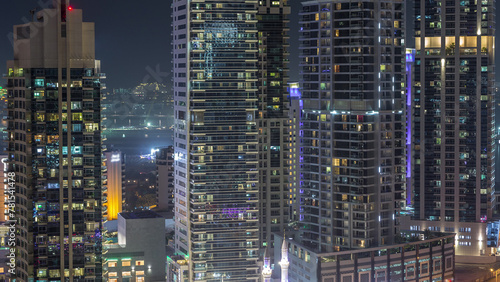 View of various skyscrapers and towers in Dubai Marina from above aerial night timelapse © neiezhmakov