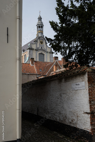 Sint-Margaritakerk in historic residences Begijnhoff in City Lier Belgium. Protected buildings are peaceful place to live, pretty landmark popular with tourists. Culture and history in Belgian life © drew