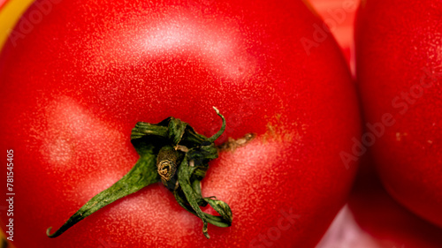 Close up of ripe red tomato, tomatoes background. © Vlad Ispas