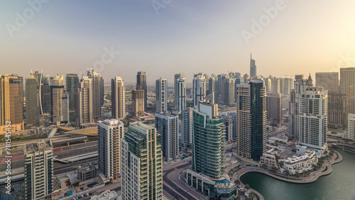 Aerial top view of Dubai Marina morning timelapse. Modern towers and traffic on the road photo