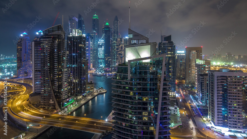 Aerial view of Dubai Marina residential and office skyscrapers with waterfront night timelapse hyperlapse