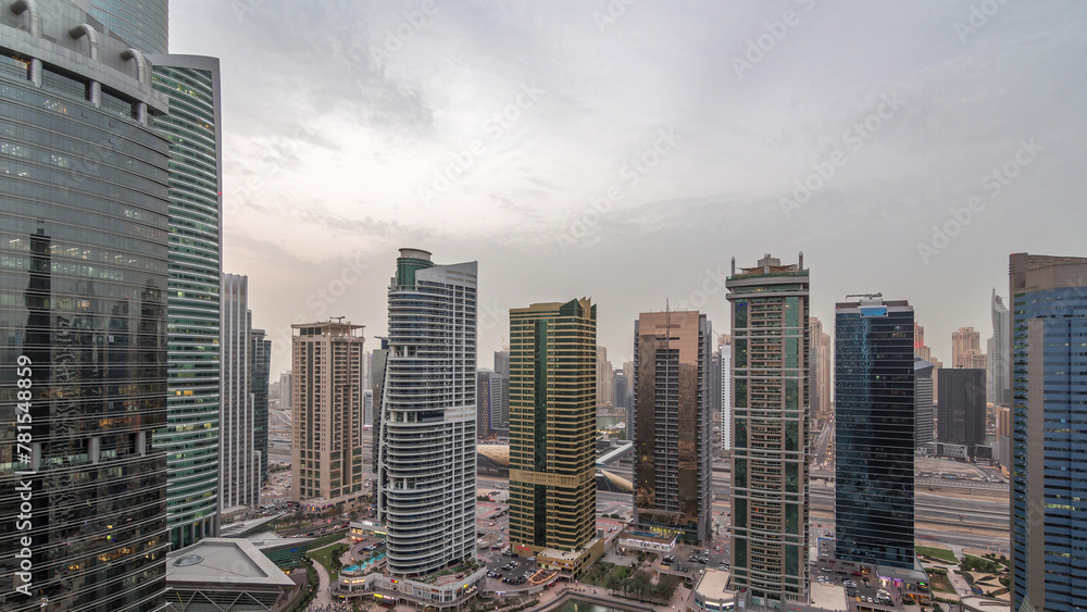 Fototapeta premium Residential and office buildings in Jumeirah lake towers district day to night timelapse in Dubai