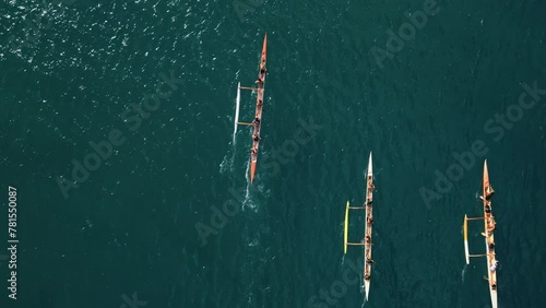Overhead shot of athletic teams compete in boating on outrigger canoe, traditional Hawaiian boat in Oahu Island, Honolulu, Hawaii. High quality 4k footage