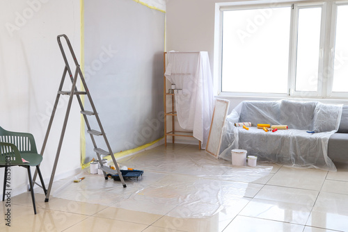 Covered furniture with repair tools in room