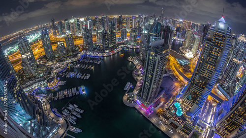 Fototapeta Naklejka Na Ścianę i Meble -  Dubai Marina skyscrapers and jumeirah lake towers view from the top aerial night timelapse in the United Arab Emirates.