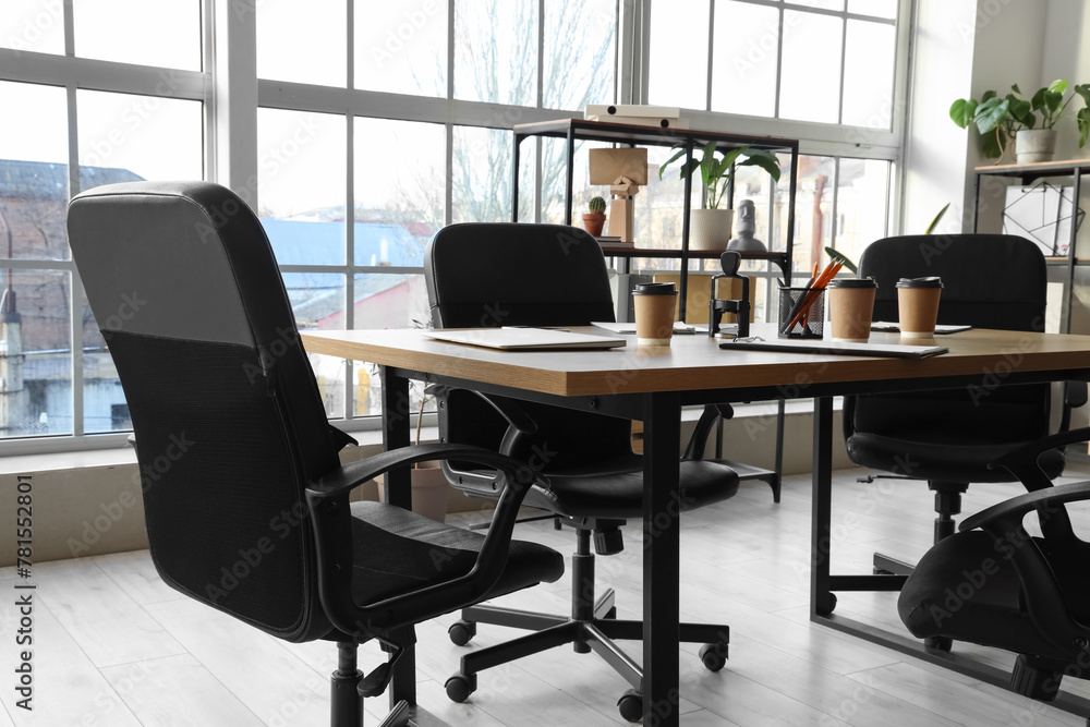 Table with coffee cups prepared for business meeting in office